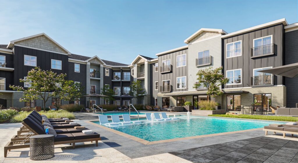 Resort-style pool at Norwood Apartments featuring lounge chairs in the water and on the deck for ultimate relaxation.